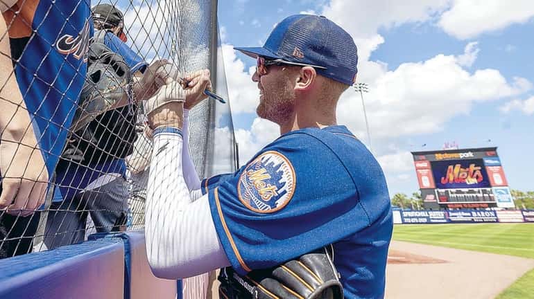 Mets outfielder Brandon Nimmo signing autographs at spring training camp Friday in...
