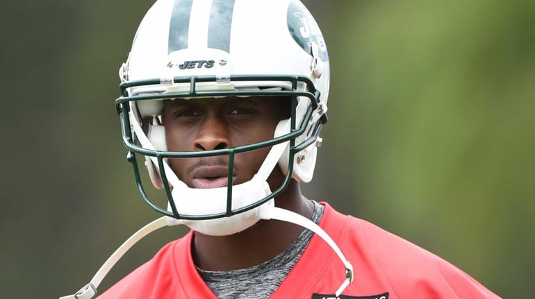 New York Jets quarterback Geno Smith looks on during camp...