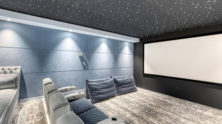 The home has a movie theater with lighting effects in...