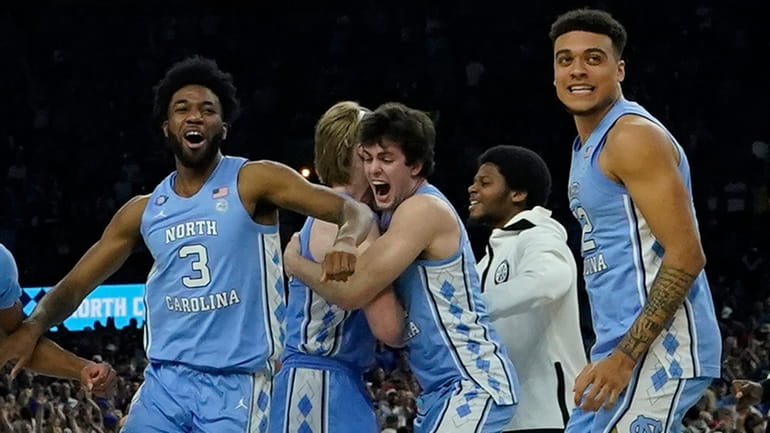 North Carolina players celebrate their victory against Duke in the semifinal...