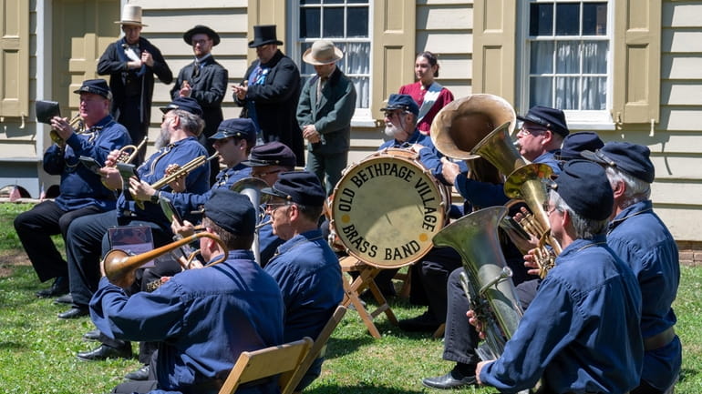 The Old Bethpage Village Brass Band preparing to perform at the...