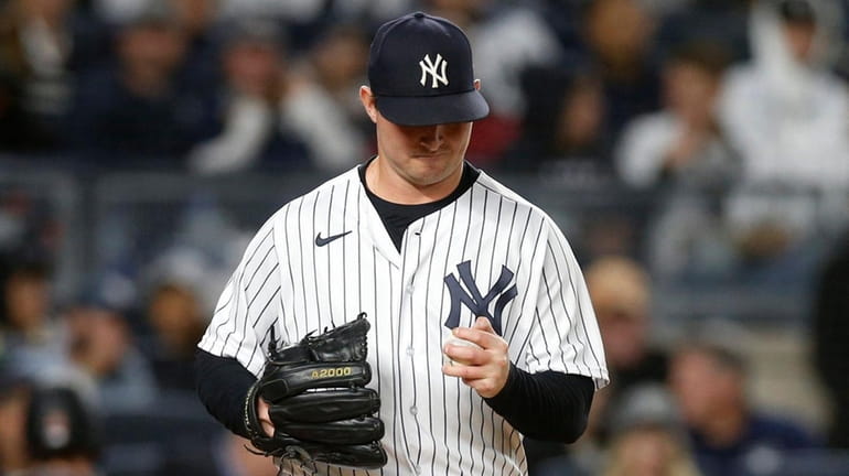Zack Britton of the Yankees reacts after his wild pitch during...