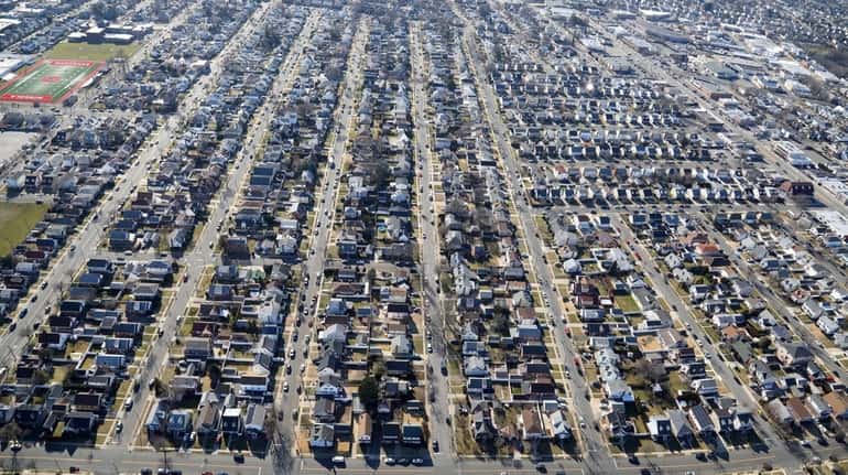 A neighborhood of houses in Mineola is seen in this aerial...