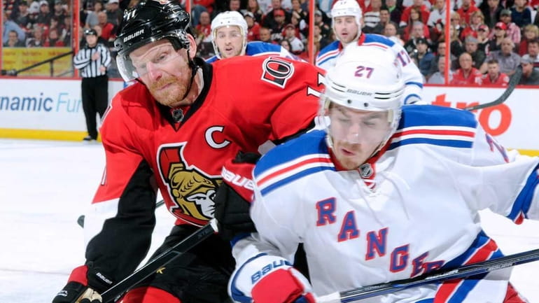 Daniel Alfredsson #11 of the Ottawa Senators chases the puck...