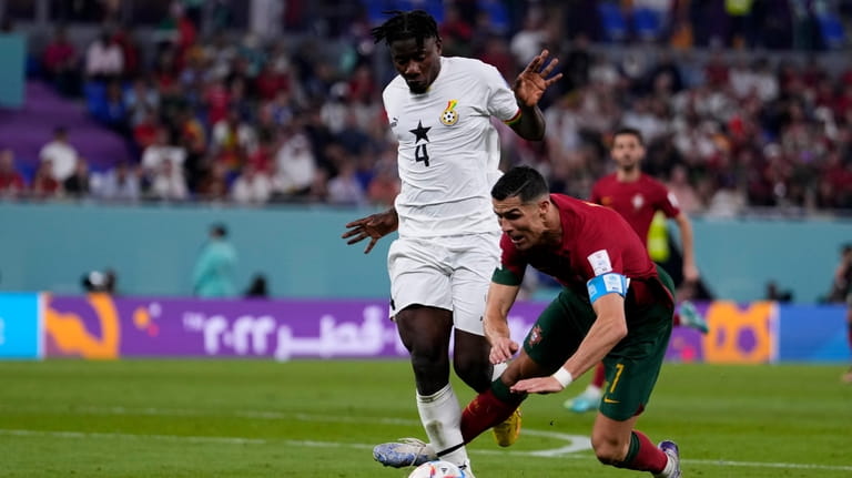 Ghana's Mohammed Salisu fouls in the penalty box Portugal's Cristiano...