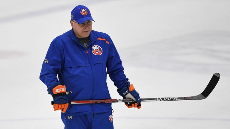 New York Islanders head coach Barry Trotz looks on from...
