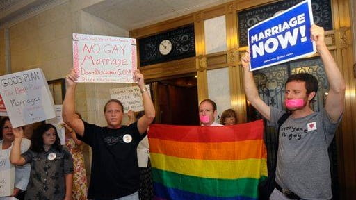 Gay marriage supporters and opponents rally in the hallway at...