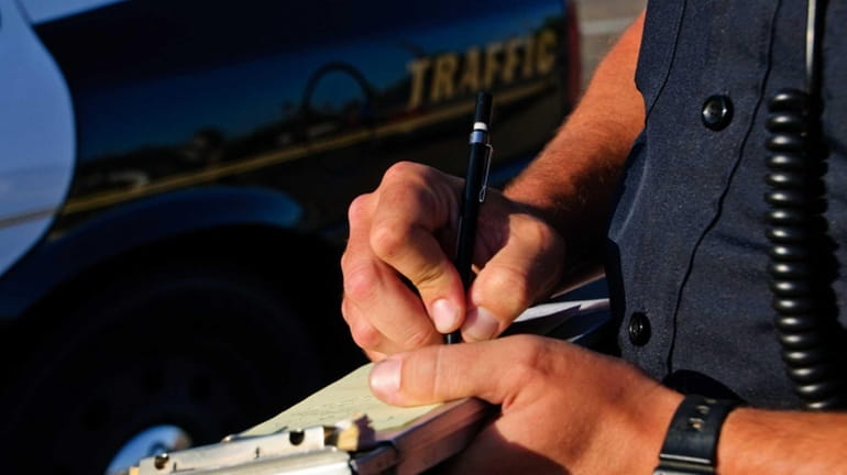 A photo of a police officer writing a ticket.