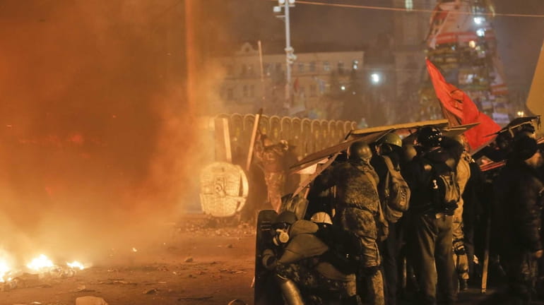 Anti-government protesters clash with riot police in Kiev's Independence Square,...