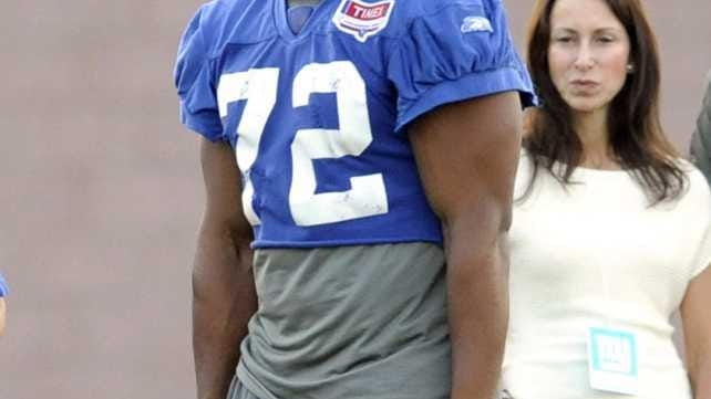 New York Giants' Osi Umenyiora watches practice during NFL football...