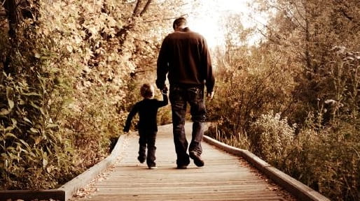 A father and son walking.