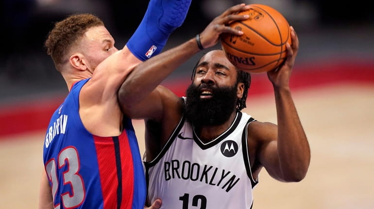 Nets guard James Harden is defended by Pistons forward Blake Griffin...