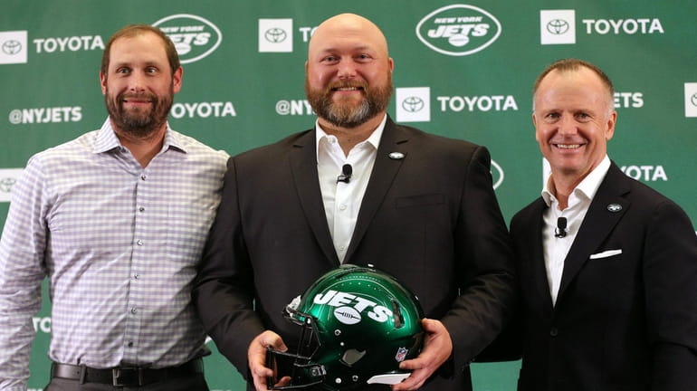 Jets new general manager Joe Douglas (center) poses for photos...
