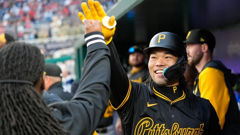 Pittsburgh Pirates' Connor Joe celebrates scoring during the eighth inning...