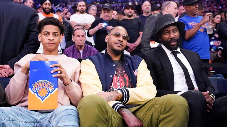 Former Knicks Carmelo Anthony, center, his son Kiyan Carmelo Anthony,...