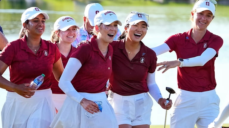 Stanford golfers celebrate with Rose Zhang, center right, after she...