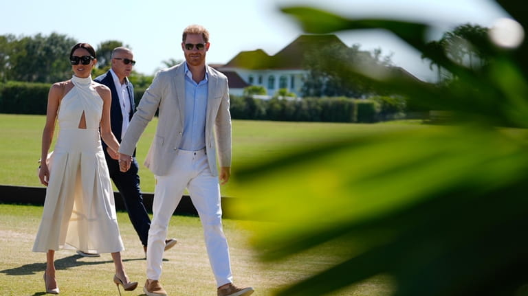 Britain's Prince Harry and wife Meghan Markle, Duchess of Sussex,...