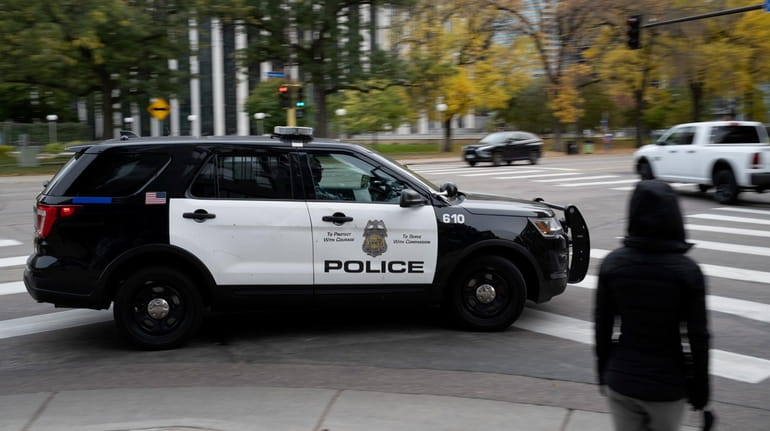 A police vehicle travels in downtown Minneapolis on Oct. 24.