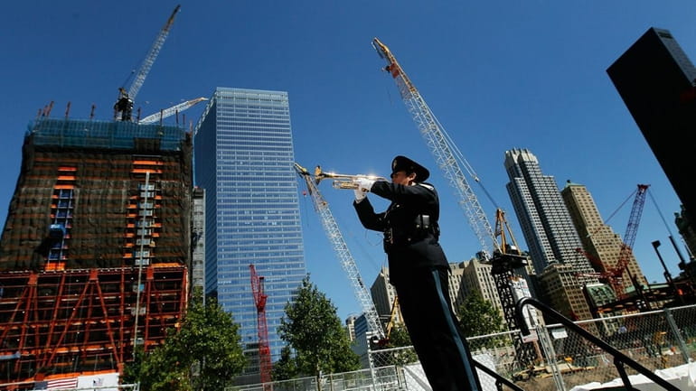 A trumpeter plays "Taps" at Ground Zero to signify the...