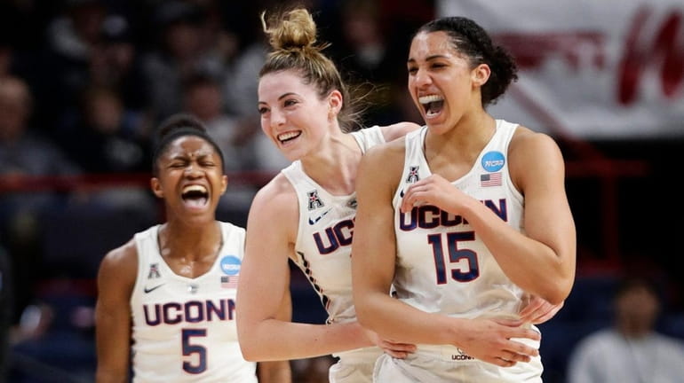 Connecticut's Crystal Dangerfield (5) and Katie Lou Samuelson (33) celebrate...