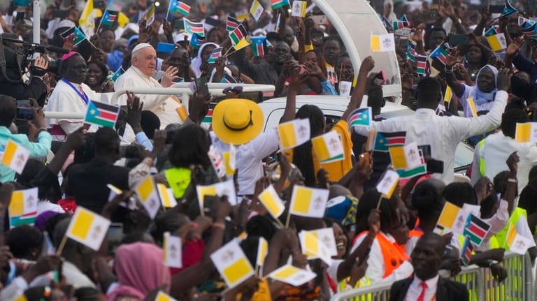 Pope Francis arrives to celebrate mass at the John Garang...