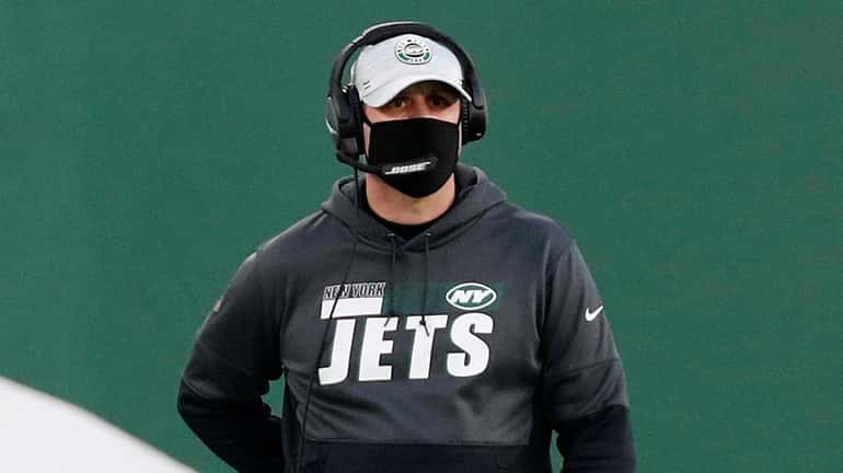 Adam Gase of the Jets looks on in the second...