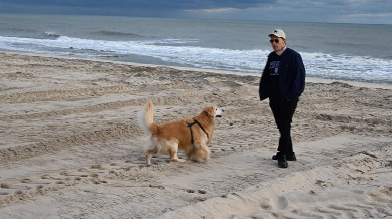 Richard DeRose of Wainscott walks his dog Thursday at the...