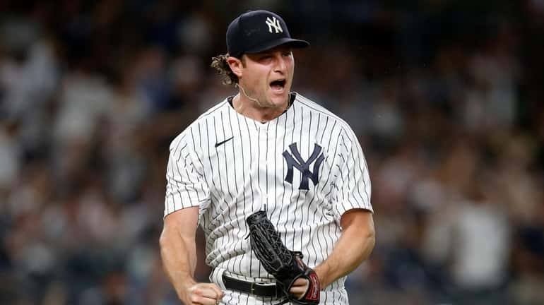 Gerrit Cole #45 of the Yankees reacts after getting a sixth...