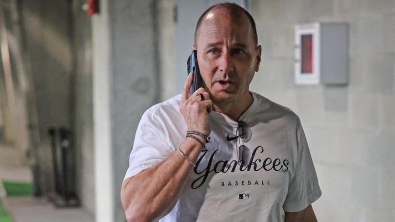 Yankees General Manager Brian Cashman speaks on the phone at George...