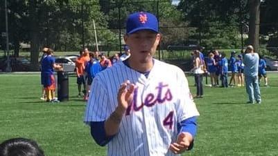 Mets' Wilmer Flores instructs campers at the Play Ball clinic...