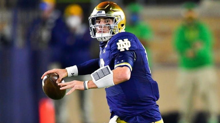 Notre Dame quarterback Ian Book looks for a receiver during...