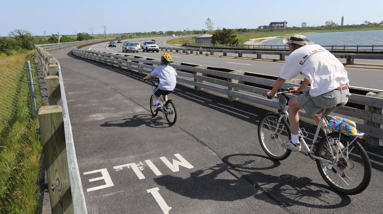 Cyclists ride the bike path along Wantagh Parkway.