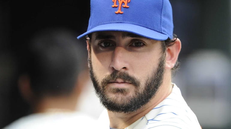 Mets pitcher Matt Harvey looks on from the dugout against...
