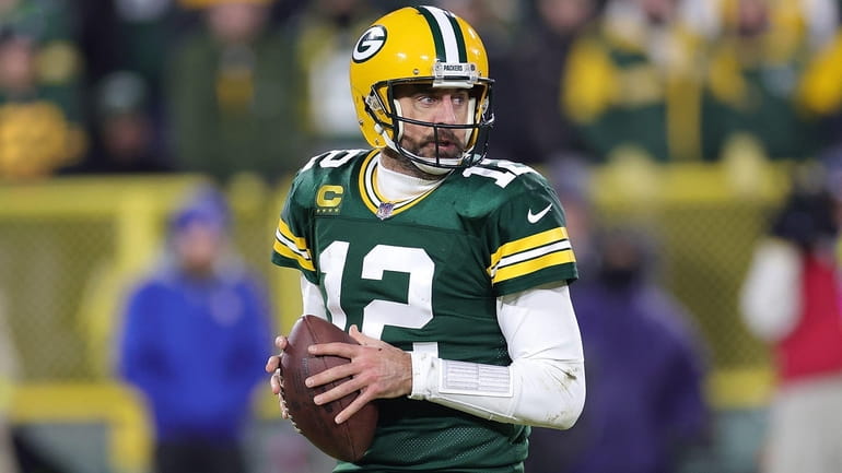 Aaron Rodgers of the Packers drops back to pass during a...
