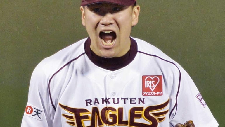 Rakuten Eagles pitcher Masahiro Tanaka celebrates after defeating the Yomiuri...