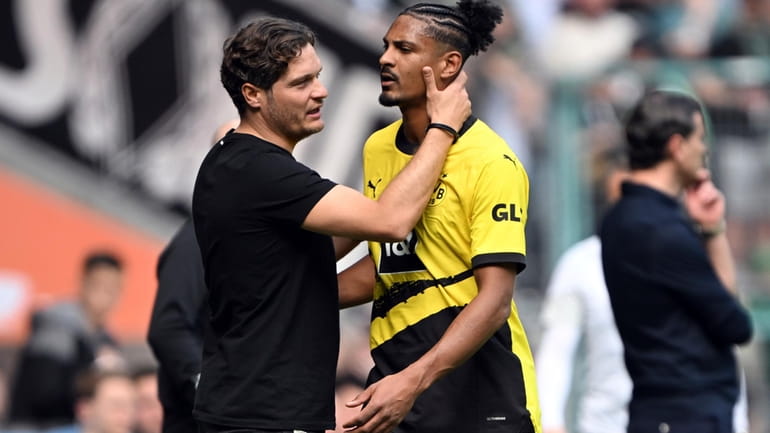 Dortmund coach Edin Terzic, left, talks to Sebastien Haller after...
