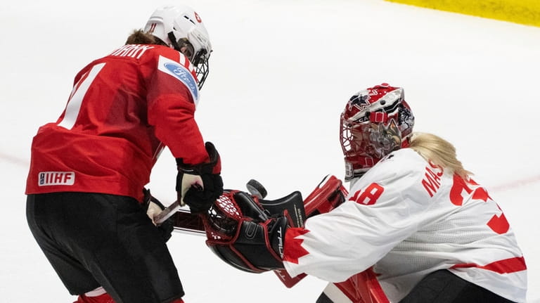 Canada goaltender Emerance Maschmeyer (38) stops a shot by Switzerland's...