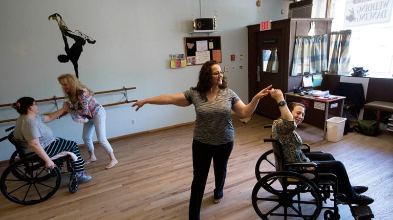 Stephanie Kanet, 32, above left, dances with Marjory Miller as...