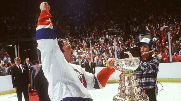 The Islanders' Bryan Trottier with the Stanley Cup at Nassau...