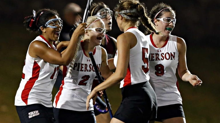 Pierson teammates celebrate the first goal of the game with...