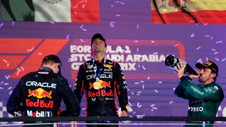 Red Bull driver Sergio Perez of Mexico celebrates after winning...