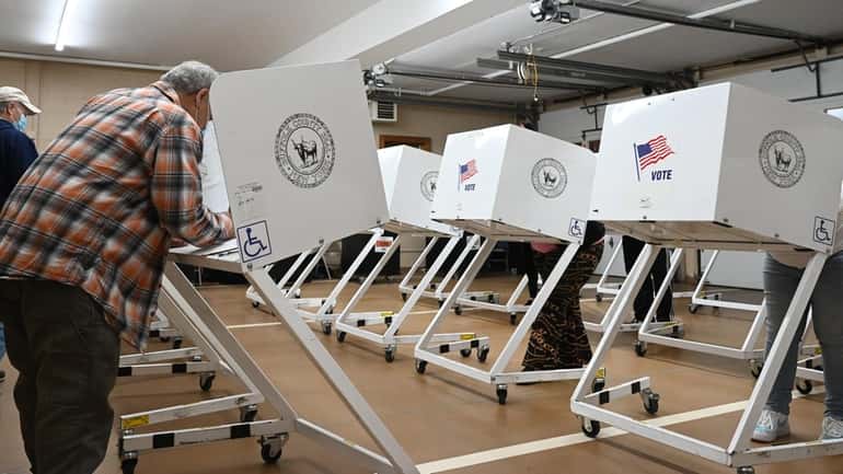 Voters cast their ballots at the Mastic Beach Fire Department...