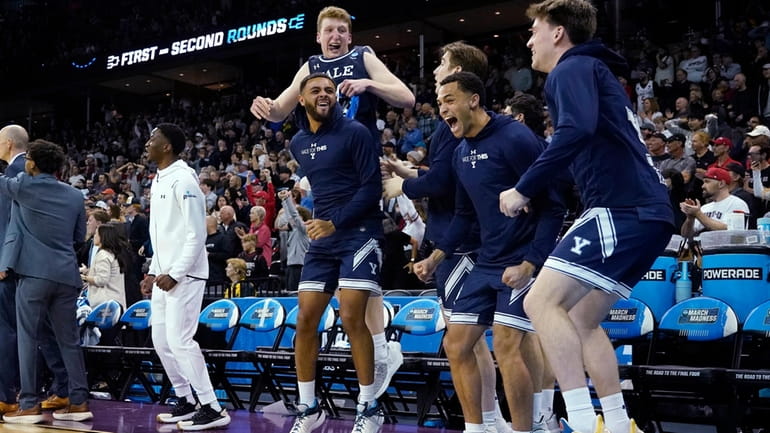 Yale players react on the bench during the second half...