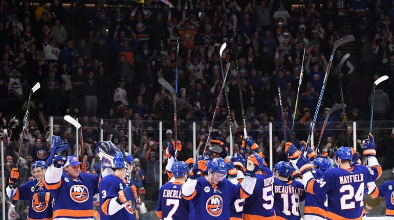 New York Islanders players celebrate their 3-2 win against the...