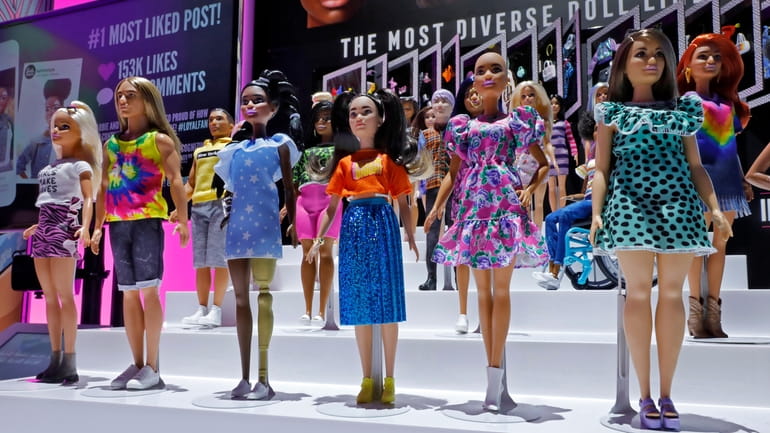 A diverse line of Barbies are displayed at Toy Fair...