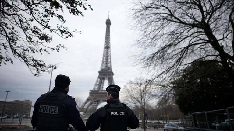 French policemen patrol near the Eiffel Tower after a man...