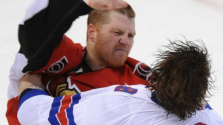 Ottawa Senators' Chris Neil fights New York Rangers' Brandon Prust,...