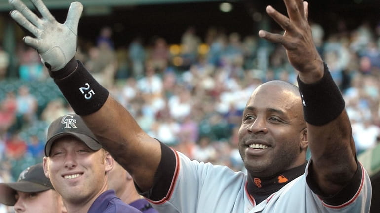 San Francisco Giants outfielder Barry Bonds gestures to a teammate...