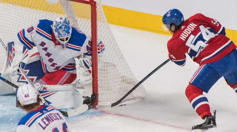 Montreal Canadiens' Charles Hudon (54) moves in on Rangers goaltender...