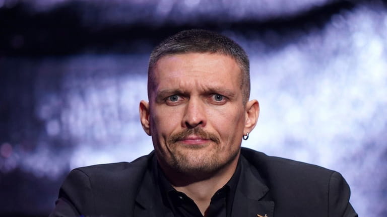 Ukrainian heavyweight boxing champion Oleksandr Usyk looks on during a...